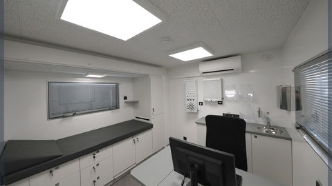 Mobile medical office with desk and examination bed